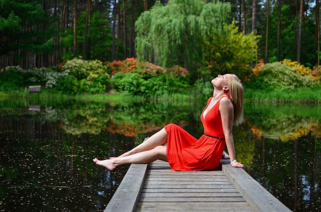 women by the pier red dress