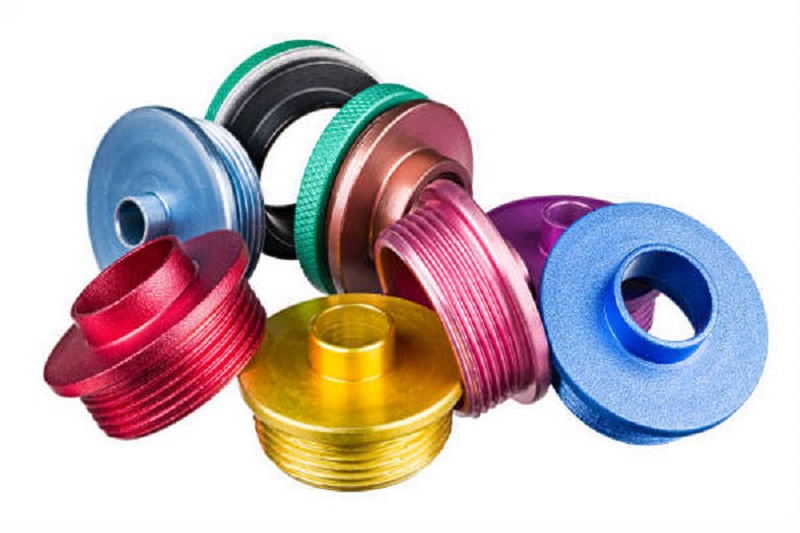 Closeup of colorful metal copy rings pile of anodized aluminum alloy. Wood shaping and milling tools accessory. Woodworking equipment