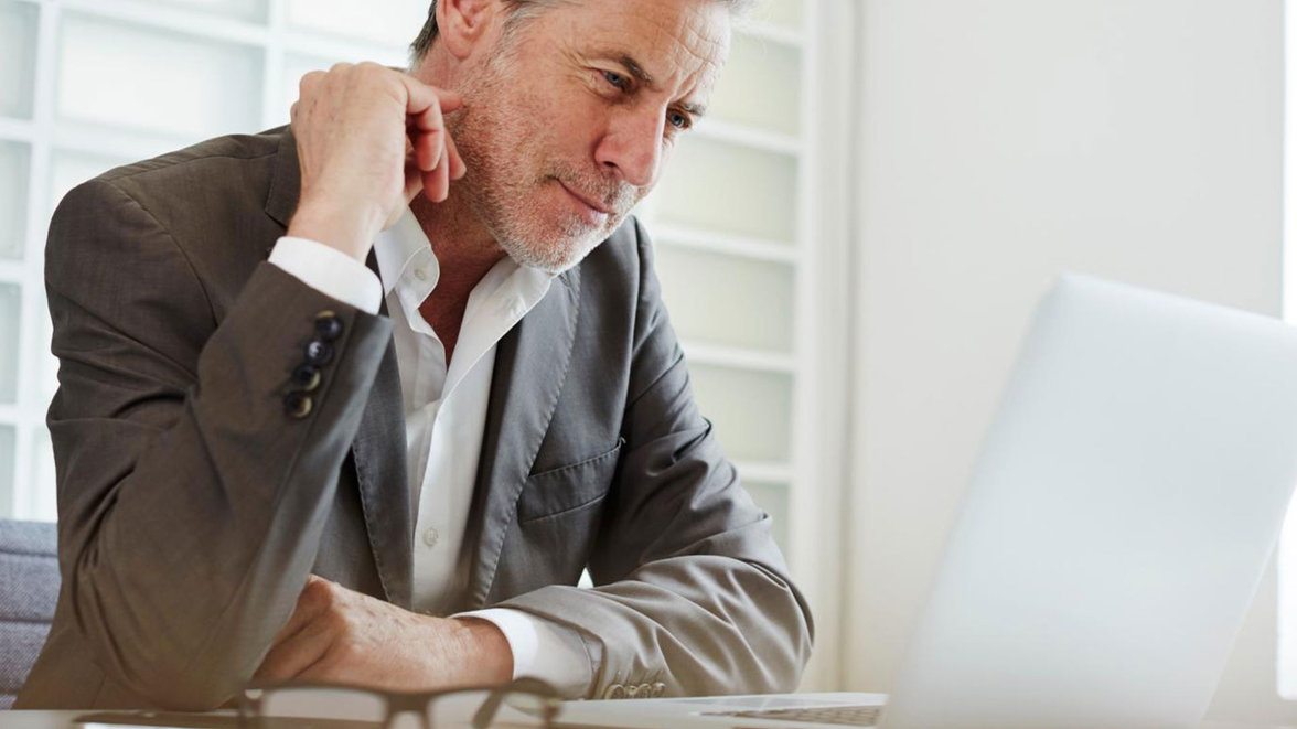 A man looking at a laptop