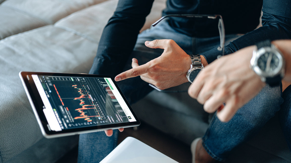 People looking at a chart on a tablet device