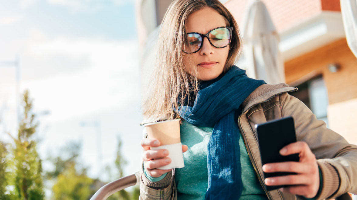 Person using a mobile phone while drinking