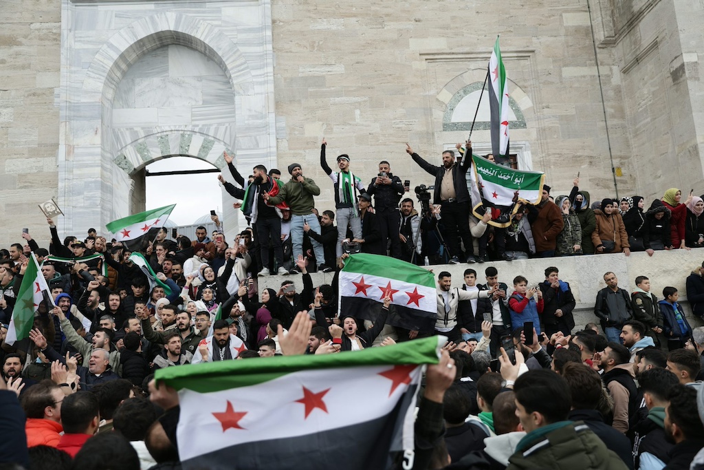Supporters of the Syrian opposition residing in Turkey wave the Syrian flag of the opposition and celebrate the rebel takeover of Damascus a mosque in Istanbul. Erdem Sahin/EPA